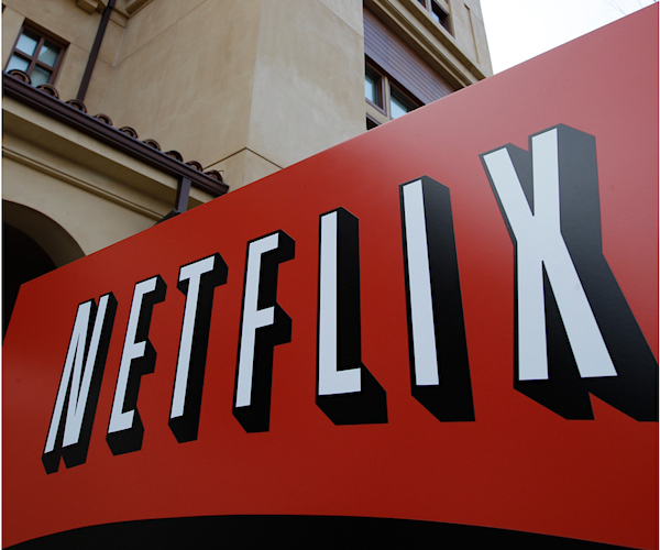 signage of netflix is shown before the backdrop of a building