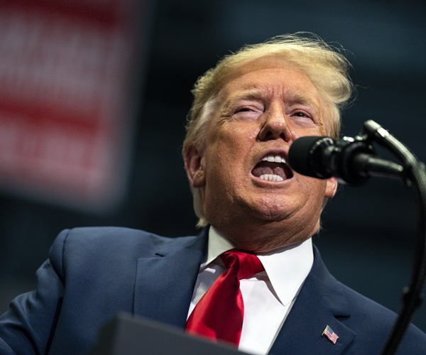 president donald trump exults during a campaign rally