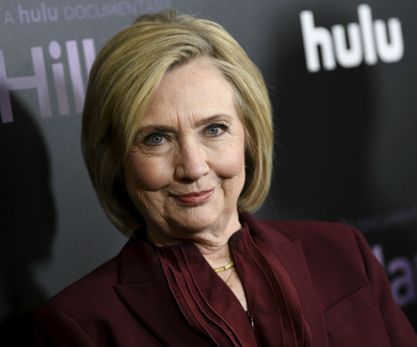 hillary clinton is shown in a burgundy suit